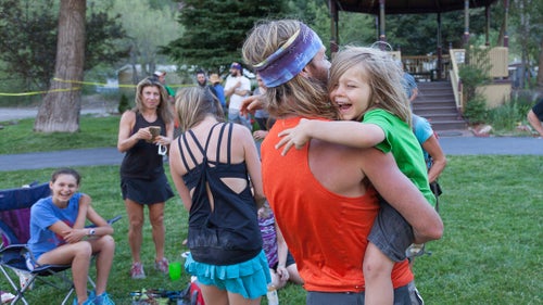 Olson hugs one of his sons at the Ouray checkpoint before continuing his race.