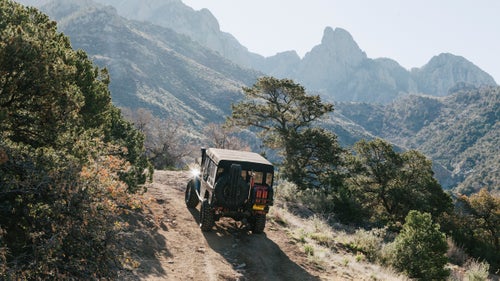 The shop removed the truck bed and replaced it with a shortened “troopy” cabin (so named because it’s made for carrying military troops). This created a truncated rear hang-over for off-roading and a spacious interior with room for a backseat. To power taller tires, they installed a 5.7-liter, 351-horsepower Chevy Ram Jet 350 engine and a reinforced five-speed transmission. They also added a twin-stick transfer case, front and rear locking differentials, and an A/C unit.