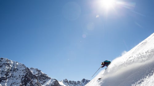 Last week, I flew down to Chile to spend a week at Ski Portillo, arguably South America’s most iconic ski area. Surrounded by tall Andean peaks, sitting next to the much-photographed Laguna del Inca, and home to the iconic Super C Couloir, it’s a bucket-list spot for many of us in North America who are not-so-patiently awaiting the return of winter.
I didn’t plan it this way, but many of the world’s best women skiers also decided to come down for the week as part of brand photo shoots or private training camps. Everywhere I looked, pro rippers were charging down big lines or sending it off Portillo’s famous rock cliffs. Many were kind enough to let me tag along for photos.
Photo: Claire Brown, an ambassador with the Blizzard Tecnica team and the publisher of SkiRacing.com, finds a pocket of snow on a bluebird day in Portillo.