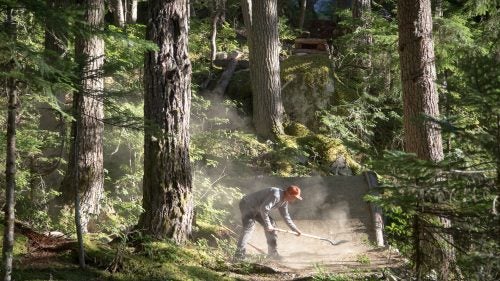 Local trail builder Scott Veach touching up the landing to the opening feature on Salsa Verde.