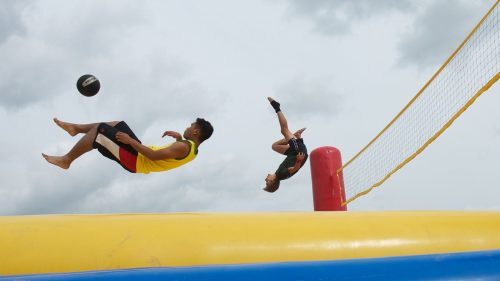 Similar to volleyball, the Belgian sport of bossaball also includes elements of soccer, gymnastics, and the martial art capoeira. Each side of the court has an integrated trampoline, allowing players to bounce high enough to spike the ball. In this photo, players warm up prior to a training session in Holland.