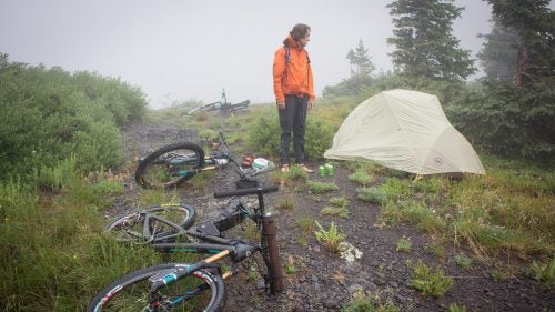 After the steepest and most brutal hike-a-bike any of us had ever experienced, we finally made it to a beautiful lake nestled high above Telluride, where we camped. Unfortunately, heavy rain resulted in frustrating fishing and lots of tent time. Here, Sam Simmons surveys our camp between downpours.