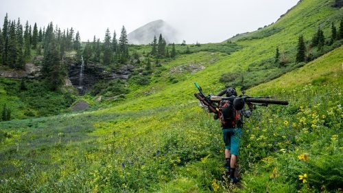 Despite warnings from a fellow fisherman about the steep and technical terrain on the trail to the first lake, we were fueled by determination to make it up the 1.2 miles. Rain made the rocks extra slippery and bushes had grown over the trail, making it nearly impassable with a bike on your shoulders. But we managed: three and a half hours later we crested the steepest part of the trail and were rewarded with a foggy view of a waterfall and large peaks in the background.