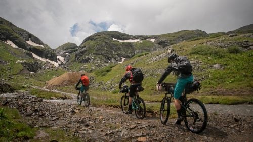 (Left to right) Reiter, Stucki, and Simmons ride past old tailings piles on their way to the top of Bridal Veil Basin on the third day of our quest.