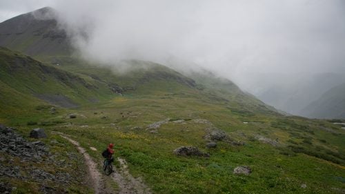 Stucki watches as the next wave of rain makes its way up the valley. For the first five days of our trip we battled through horrendous weather. Cold rain at nearly 13,000 feet, for days on end, makes for an epic journey.
