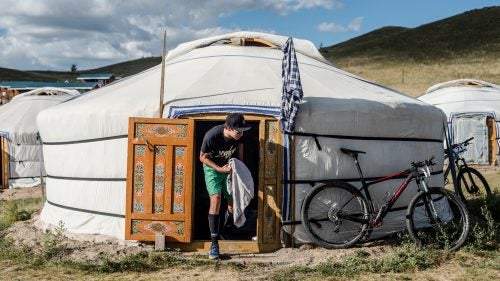 McElveen exits a Mongolian yurt, or “ger,” in one of the camps where the racers stayed. Each ger includes four beds against the walls and a wood stove in the middle.