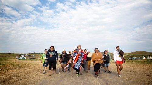 Peggy Wellknown Buffalo of Montana’s Apsaalooke (Crow) Nation leads a group of women through camp to the banks of the Cannonball River for a ceremony just after dawn. Those who’ve gathered to oppose the pipeline have frequently been described as activists and demonstrators by the media, but many of them argue those terms are inaccurate. They say the camp is a place for peace and prayer, and that they have come to protect, not protest.