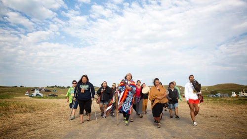Peggy Wellknown Buffalo of Montana’s Apsaalooke (Crow) Nation leads a group of women through camp to the banks of the Cannonball River for a ceremony just after dawn. Those who’ve gathered to oppose the pipeline have frequently been described as activists and demonstrators by the media, but many of them argue those terms are inaccurate. They say the camp is a place for peace and prayer, and that they have come to protect, not protest.