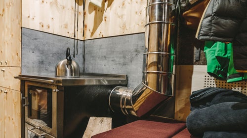 The interior is made from Austrian pine. Infracom and Tschetschonig, in southern Austria, did the woodwork. The interior sleeps eight—two bunk drawer beds, a foldout that fits two, and four above the driver’s cabin—and includes a wood-burning stove from Pertinger.