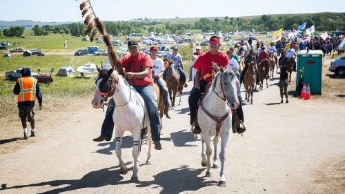 Riders lead a protest march out of camp toward a nearby Dakota Access Pipeline construction site in late August. With thousands of of people living near the oil pipeline’s proposed route, such marches are a regular occurrence and usually attract hundreds of participants.