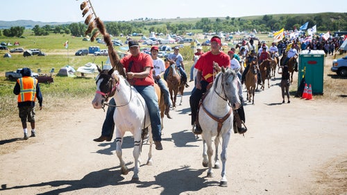 Riders lead a protest march out of camp toward a nearby Dakota Access Pipeline construction site in late August. With thousands of of people living near the oil pipeline’s proposed route, such marches are a regular occurrence and usually attract hundreds of participants.