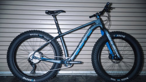 From a featherlight race 29er to a fattie that pedals like a normal steed, these were some of the coolest and most promising new rides we saw at Interbike. Just starting out? Learn everything you need to know about buying your first mountain bike.
Photo: Otso Voytek
Otso is a new bike brand from the same folks behind Wolf Tooth Components, and their two new bikes, including the Voytek, are as clever and well-conceived as their small parts. Otso engineer and brand manager Brendan Moore calls it a “plus bike that fits fat,” because the carbon frame can be equipped to accommodate both 27.5+ and 29+ wheels, as well as 26ers with up to 4.6 rubber. The versatility comes courtesy of a proprietary, three-way flip chip at the rear dropouts, which not only allows the wheel swaps but also makes it possible to change the rear chain stay length (between 430mm and 450mm in ten millimeter increments), thereby changing the bike’s entire feel and handling. The Voytek also has the narrowest Q-factor of any fat bike out there (thanks to a special Wolf Tooth chain ring), which will make it ride more like a standard hard tail than a fatty. It’s the bike I’ve been wanting for years because, at last, your year-round rig can double as a winter fattie without compromise in either format. Complete bikes start at $3,900.