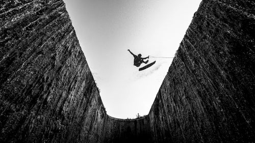 Wings category finalist by Jan Kasl
This image shows wakeskater Andrew Pastura at the Red Bull Winch Sessions in the Czech Republic and Slovakia in summer 2015.
“This was the last day of the photo shoot and I was already pretty happy with all the photos I had taken so far, but we decided to check one more location and that was this amazing gap on a remote lake in Slovakia,” Kasl says. “The guys were setting the winch and I jumped into the hole, where I buried myself ankle-deep in the mud and found the most impressive angle I could imagine.”