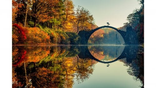 The Red Bull Illume photo contest, now in its 10th year, highlights the best images and photographers in the outdoor adventure world. Fifty-three premier photo editors whittle down almost 35,000 images into 55 finalists. Those images are separated into 11 categories, with a winner in each, plus a grand prize winner. Tens of thousands of dollars in gear await the winners, in addition to bragging rights from one of the most prestigious photo contests on earth. Here a preview of some of the incredible work.
Photo: The grand prize was awarded—for the second time—to the German photographer Lorenz Holder for this shot of Senad Grosic in Gablenz, Germany. “One thing that was a little annoying was that the lake was covered with leaves which had fallen from trees, so the reflection of the bridge in the lake was just not there,” Holder says. “But sometimes you just need a bit of luck—I had been on a fishing trip some days before and still had my fishing-boots and a net in the car. So got the stuff and tried to clean the lake by hand. It took a while until it was almost perfectly clean—at least where it was relevant for the picture. Luckily the sun was still very soft, so we had good light for the shot.”