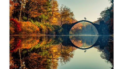 The Red Bull Illume photo contest, now in its 10th year, highlights the best images and photographers in the outdoor adventure world. Fifty-three premier photo editors whittle down almost 35,000 images into 55 finalists. Those images are separated into 11 categories, with a winner in each, plus a grand prize winner. Tens of thousands of dollars in gear await the winners, in addition to bragging rights from one of the most prestigious photo contests on earth. Here a preview of some of the incredible work.
Photo: The grand prize was awarded—for the second time—to the German photographer Lorenz Holder for this shot of Senad Grosic in Gablenz, Germany. “One thing that was a little annoying was that the lake was covered with leaves which had fallen from trees, so the reflection of the bridge in the lake was just not there,” Holder says. “But sometimes you just need a bit of luck—I had been on a fishing trip some days before and still had my fishing-boots and a net in the car. So got the stuff and tried to clean the lake by hand. It took a while until it was almost perfectly clean—at least where it was relevant for the picture. Luckily the sun was still very soft, so we had good light for the shot.”
