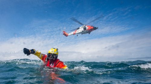 I’m an underwater photographer, but you won’t find many macro images of coral or clownfish in my portfolio. I’m inspired by the people who connect most directly with the water: freedivers, researchers, filmmakers, and, above all, rescue swimmers of the U.S. Coast Guard (USCG). It’s fascinating to think that a multi-million dollar helicopter and rescue swimmer, wearing just a pair of fins, work together to accomplish the same mission. It is a highly specialized pairing of man and machine. But the most important part of the story is how rescue swimmers train to do their jobs in the worst conditions, all in an effort “so others may live,” the USCG rescue swimmer motto. Over the past few months, I’ve worked closely with these heli-jumping heroes. Wherever I went in connection with this project, I received incredible access and support from all levels of the Coast Guard. I qualified at Air Station Savannah in Georgia to exit a hovering helicopter by rescue hook. I swam alongside recruits in Elizabeth City, North Carolina, as they attempted to pass the rescue-swimmer course. I shot photos of these professionals in the midst of severe physical pain and mental challenges. I also deployed with Air Station Kodiak and Air Station Miami, where I swam under thundering helis and watched, from a water-level perspective, these rescuers in action. Photo: Aviation Survival Technician 3rd Class (AST3) Robert Burke swims away from a MH-60T Jayhawk helicopter near Kodiak, Alaska.