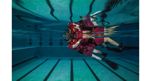 Class 119-16. AN Tyler Sojka “buddy towing” his partner, AN Anthony Troche. Sojka's hip is placed into the small of the survivor's back, and with a fast, forward kick, the survivor is raised to the water's surface.