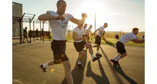 AN Steven King (left) and AN Tyler Sojka (middle front) doing the daily morning workout.