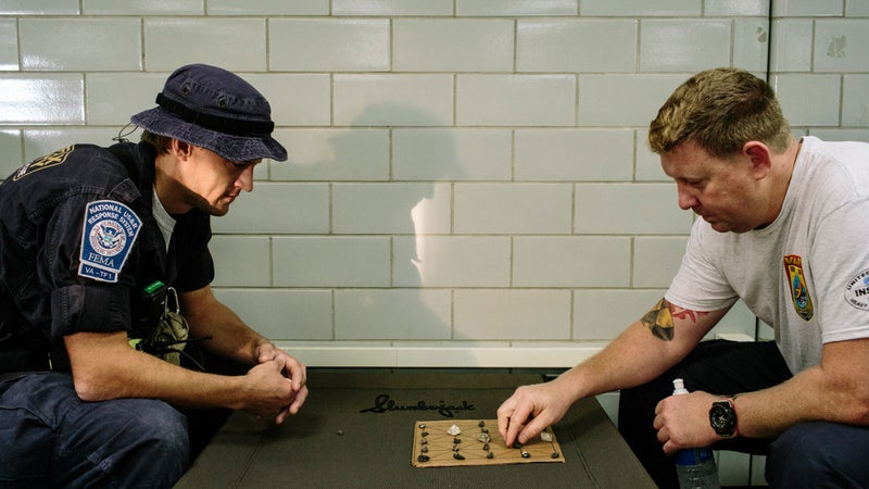 Brenden Petersburg (L) and Bill Ward play "Goats & Tigers," which Petersburg learned from Nepalese relief workers while assisting with earthquake relief efforts in Nepal in 2015.