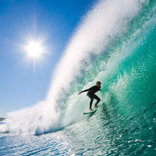 Surfer on perfect wave in the barrel