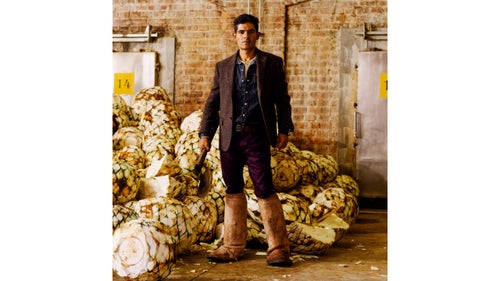 At the Patrón Hacienda, a Spanish-colonial-inspired campus and distillery in the high plateaus outside the city that serves as the company’s headquarters, Bravo is a hornero, cutting up 80-pound agave hearts for baking and distilling. Rather than grow their own, Patrón buys its agave from area farmers, and hundreds of plants are delivered each week. To make tequila, the hearts are baked in large ovens, then crushed with an ancient tahona mill or a slab of volcanic rock to extract the juice. The liquid is then fermented, distilled, and, in the case of some specialty tequilas, aged in handmade barrels for more than a year.
Single-Breasted jacket by John Varvatos ($598); Classic Western shirt by Levi’s ($128); Stretch Chinos ($98) and belt ($45) by J.Crew