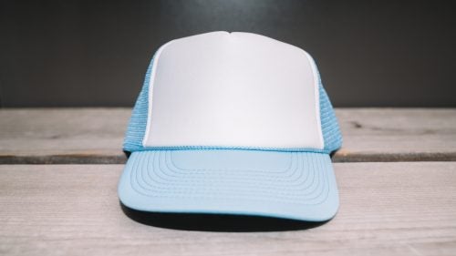 The polyester Two Tone comes in a ton of colors and is dirt cheap. Plus, the blank front stands out in a sea of logos.