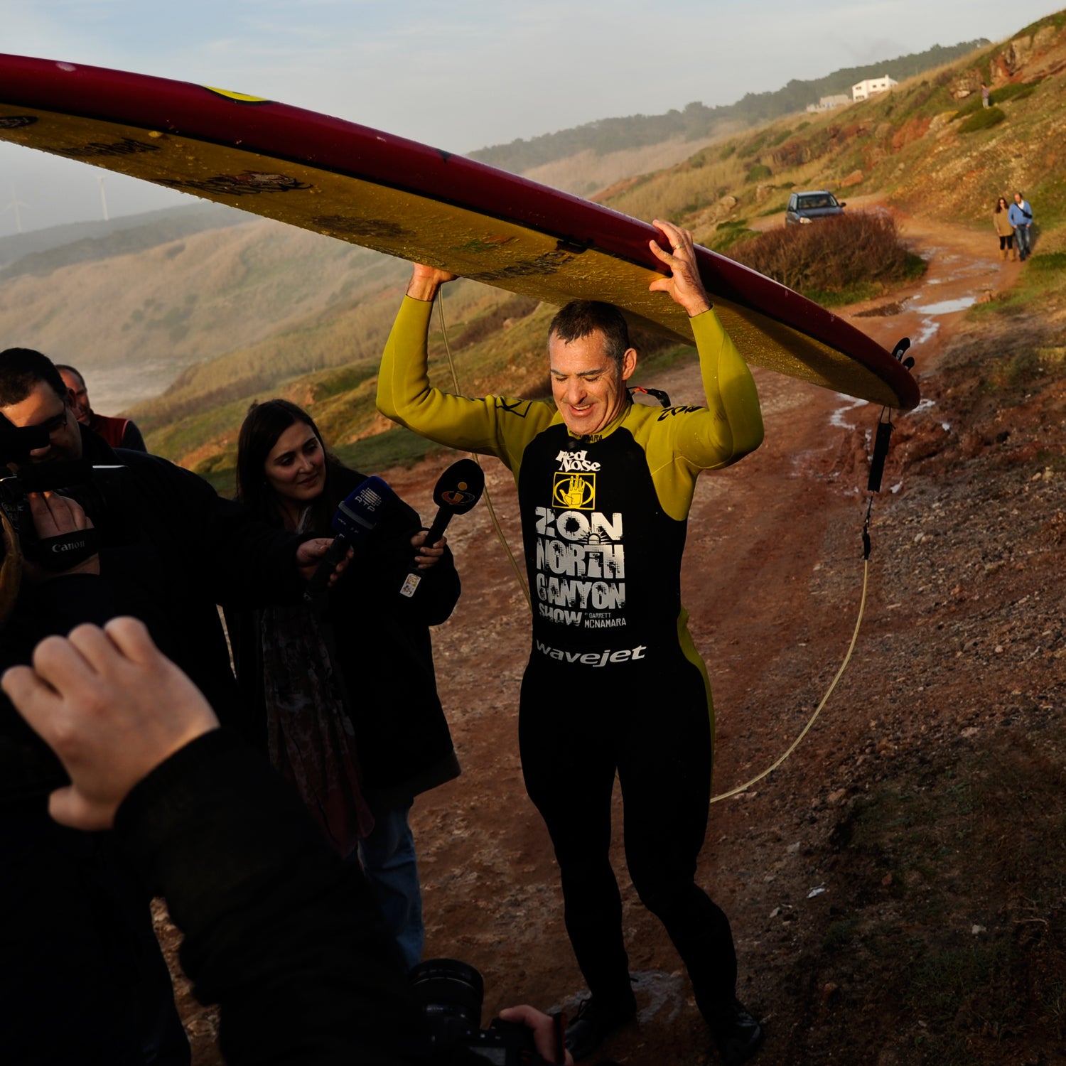 Hawaiian surfer Garrett McNamara carries his surfboard as he leaves the beach after a surf session at Praia do Norte in Nazare on January 29, 2013. McNamara arrived on January 28 at Praia do Norte, the