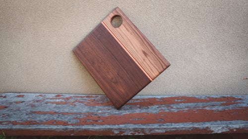 Built from locally sourced walnut wood and sealed with mineral oil, this pretty cutting board has a recycled piece of skateboard deck running down one side.