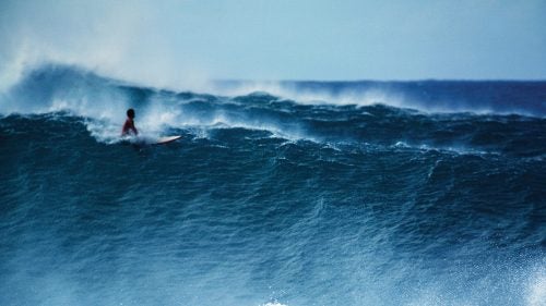 Pipeline, Oahu, Hawaii, December 1978. Another classic Pipeline shot of solo surfer feeling a huge set roll toward the beach.
