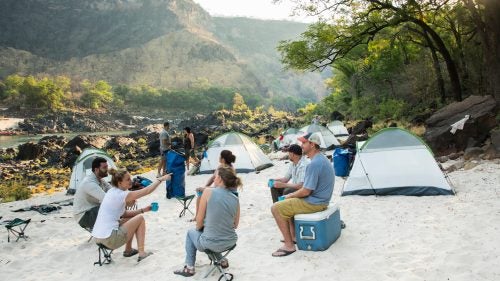 Massive fluctuations in river levels often push white sands high above the riverbank, as seen at the first camp, near Rapid 21. There, the group recounted a big day on the river—for some, it was their first whitewater experience.