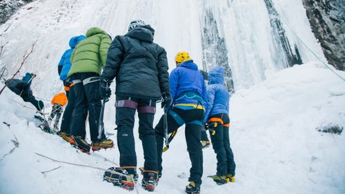 Climbers looking up at Genesis One as their instructor shows them how to spot weaknesses in the ice.