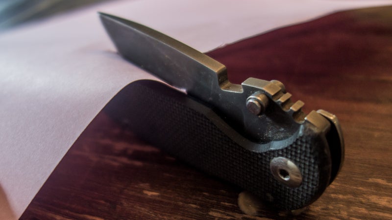 By creating an acute angle between the handle and the blade, you can shear through sheets of paper and other materials. Your blade must be kept razor sharp to do this though.