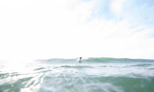 Therrien enjoying a sunny-day swell in Frankfort, Michigan—a freshwater surfing hot spot.