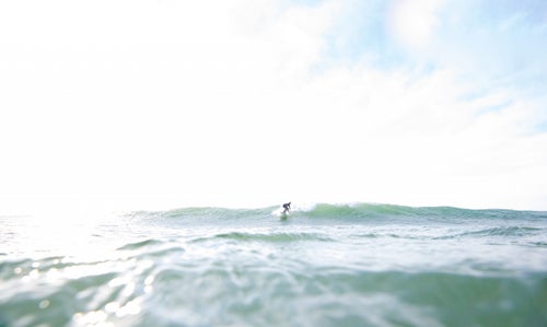 Therrien enjoying a sunny-day swell in Frankfort, Michigan—a freshwater surfing hot spot.
