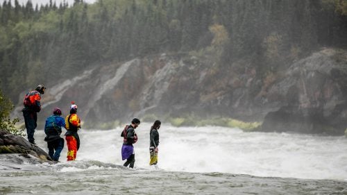 Doused in rain, Kalob Grady, Bren Orton, Dane Jackson, Jon Patterson, and Tom Patterson look on at the chaos of White Mud Falls, the only rapid on the Nelson which has still not been attempted.