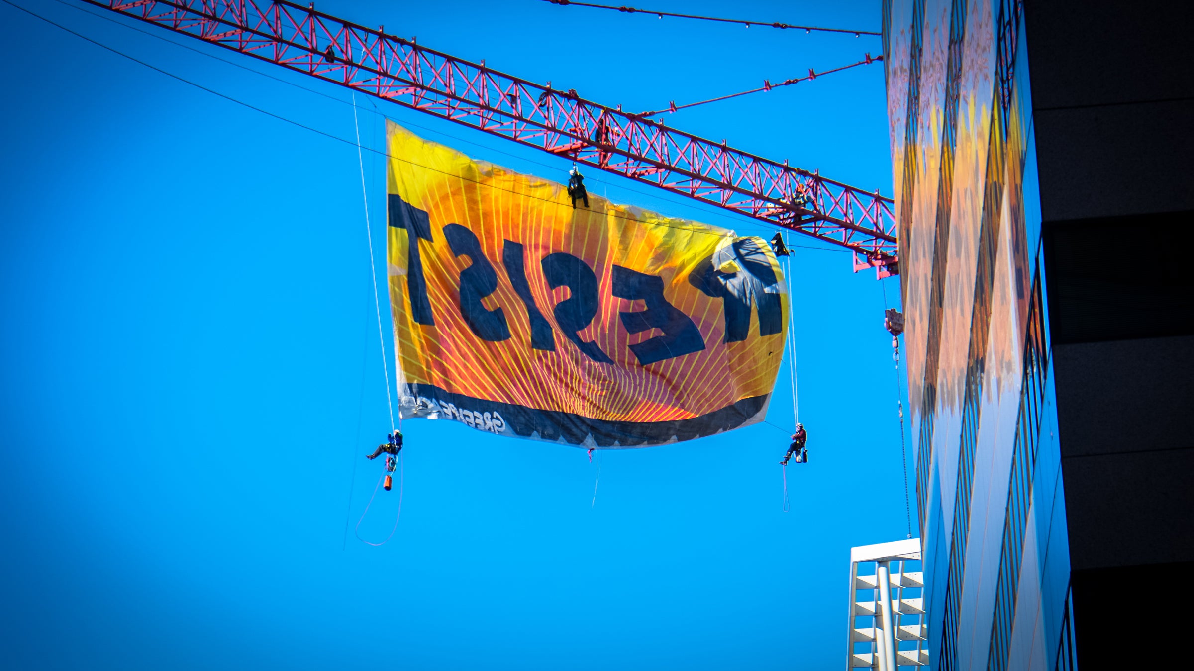 Greenpeace protestors unfurl a banner reading "Resist" over downtown Washington, D.C.