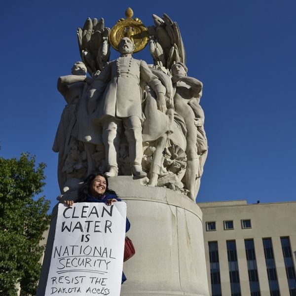 A protestor outside of the E. Barrett Prettyman US Courthouse, home of the US Court of Appeals for the DC Circuit.