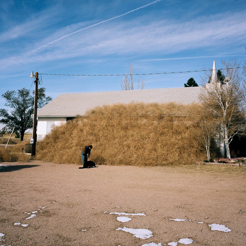 Pastor Ragan Simpich posing for a portrait with his dog at Hanover Community Church. Hanover, Colorado.