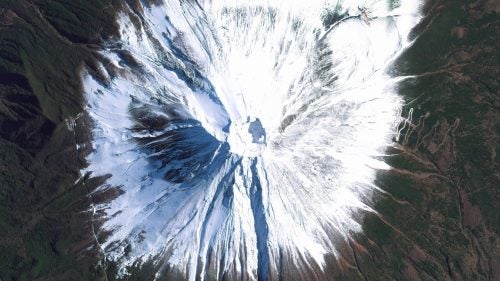Mount Fuji is an active stratovolcano and the tallest peak in Japan, rising 12,389 feet. As seen in this image, Fuji has an extremely symmetrical cone, which is snow‐capped several months of the year. During warmer months, trekking routes make it possible for hundreds of thousands of people to scale the volcano each year.