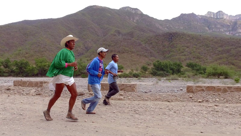 Arnulfo Quibisare runs with Silvino Cubesare and Manuel Luna.