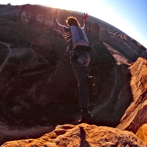 Dean Potter base jumping off the Tombstone cliff outside of Moab, Utah.