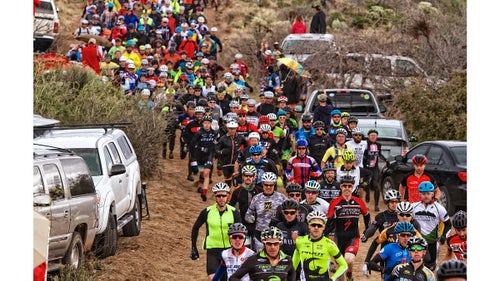 The race began at 12 p.m. sharp with a run to the bikes, which were loosely stacked together about a quarter-mile away. Then it was on to the 16-mile loop, which crossed over seven rolling hills filled with front-wheel-bending ruts and plenty of spots where spectators lined up to witness potential disaster or inspiration. Upon completing a lap, team members handed off their batons at an exchange tent, where their time was recorded, then they refueled and slept until the cycle repeated.