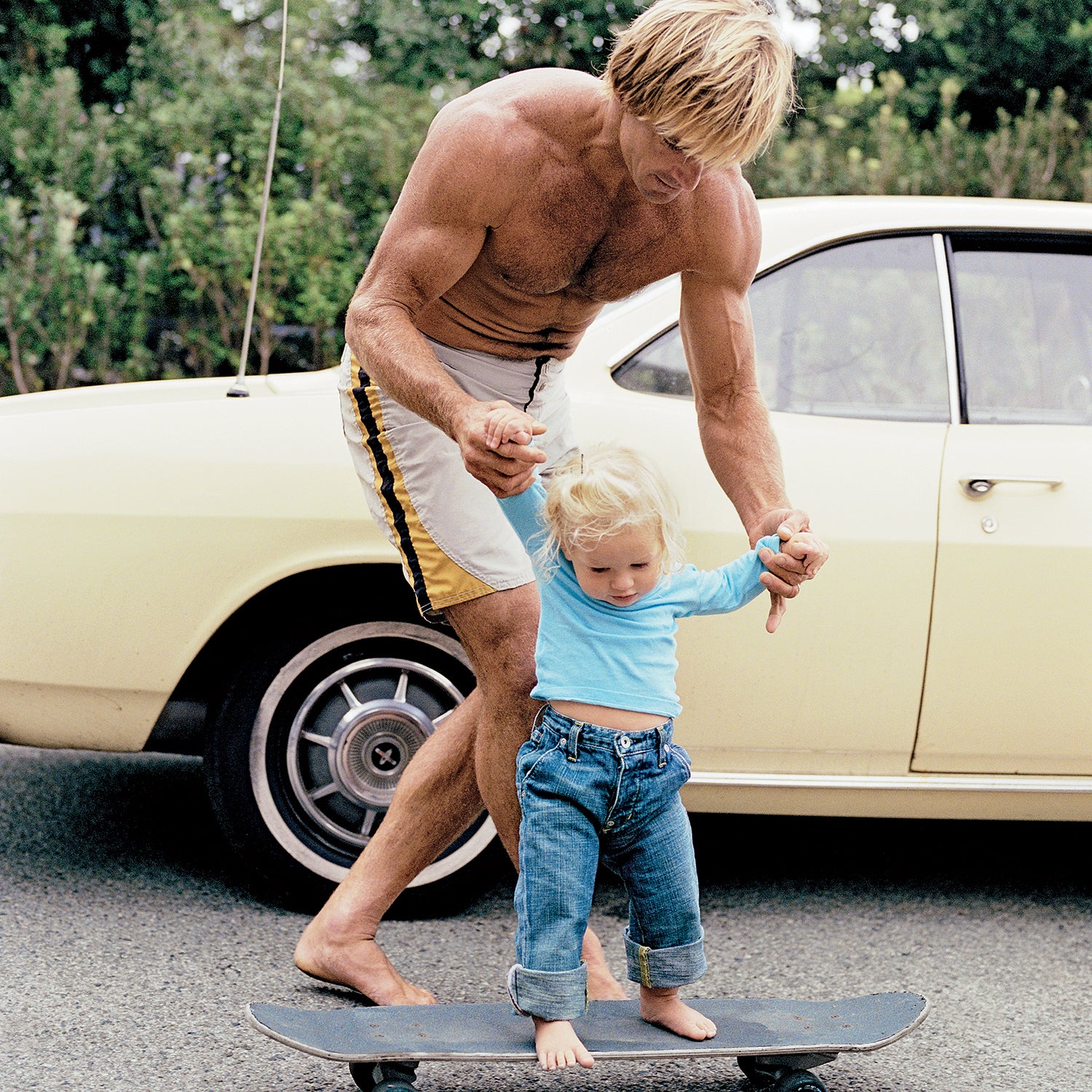 Early does it: Laird Hamilton introduces his daughter Reece, age one, to board sports