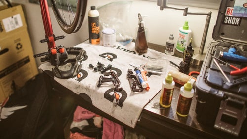 Though a real work table would be preferable, a desk works just fine for Baddick. “It’s got a nice secret drawer that pulls out, so I always have an empty space.” A bookcase shoved in the corner holds water bottles, nutrition, and other odds and ends.
