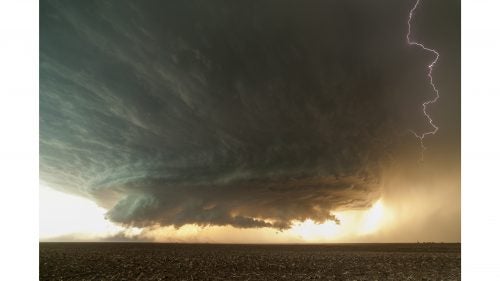 My earliest memory of a storm was watching lightning in the backyard with my dad when I was a kid. A bolt hit so close that I remember being blinded by it. Perhaps that’s why, when I became interested in photography in my mid-30’s, I focused on these electric events. Soon I was chasing supercells and tornadoes on the central plains. It’s exhilarating. I’m based in Phoenix, and for three months last spring I drove to and from the plains, chasing for 18 total days and putting over 25,000 miles on my Toyota 4Runner. You almost need to be an addict to get the shots I get. You’ll drive all night to Colorado, never sleep, chase all afternoon, get incredible images, then drive to Texas the next day, maybe get a few more hours of sleep, and then chase again that afternoon. Then repeat—maybe in Kansas. The following are my favorite shots from the six years on the road. Photo: A post-apocalyptic-looking supercell spins over the dusty farmlands of the Texas Panhandle.
All images by Mike Olbinski.