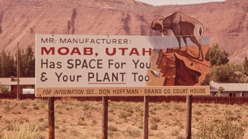 A sign advertises Moab as a destination for industry, not tourism, in 1972.