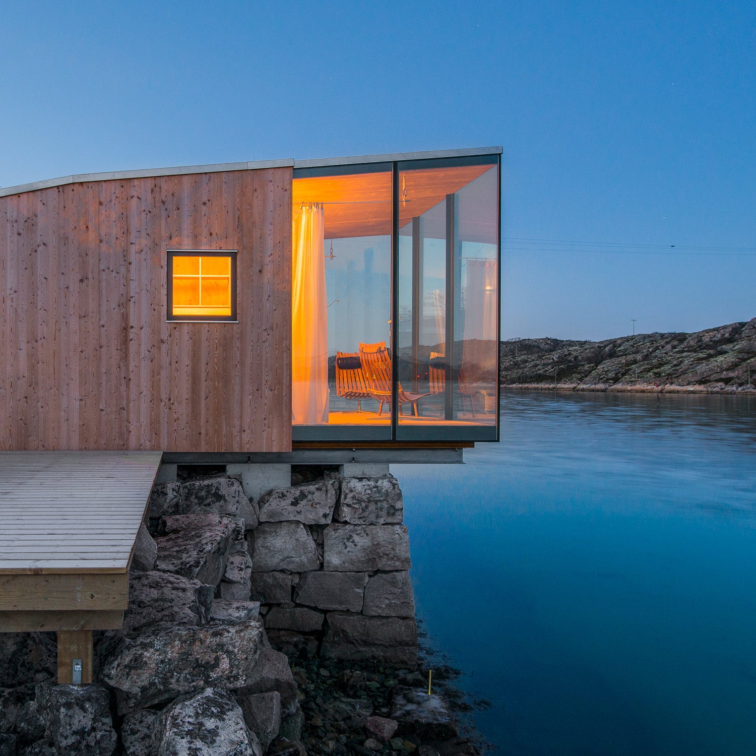 A sea cabin cantilevered over the Grotoya Strait, Manshausen Island, Norway.