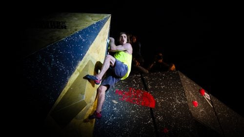 After wrestling with this problem for nearly the duration of his four-minute allowance, Daniel Woods finally makes it to the top of this volume-only route. Here, he lets out a whoop after reaching the top.