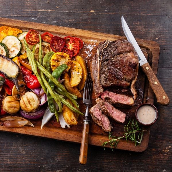 Steak with pepper sauce and grilled vegetables—a favorite among post-race meals.