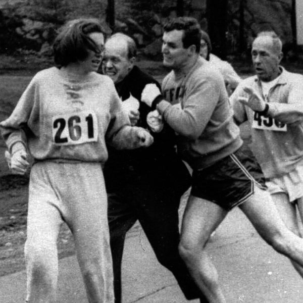 A woman, listed only as K. Switzer of Syracuse, found herself about to be thrown out of the normally all-male Boston Marathon when a husky companion, Thomas Miller of Syracuse, threw a block that tossed a race official out of the running instead, April 19, 1967 in Hopkinton, Mass.(AP PHOTO)
